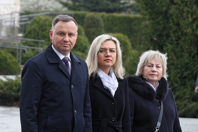 duda_wassermann Kraków, 10.04.2022. Prezydent Andrzej Duda (L), posłanka PiS Małgorzata Wassermann (2L) i jej matka Halina Wassermann (3L) na cmentarzu parafialnym na krakowskich Bielanach, gdzie złożyli wieniec na grobie Zbigniewa Wassermanna. Foto: PAP