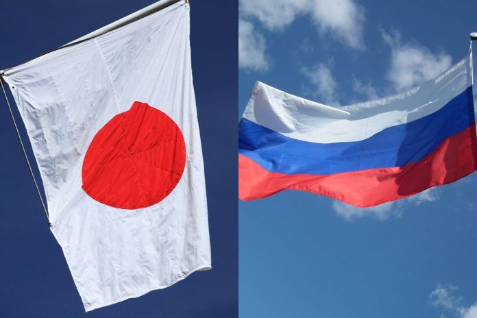 Flagi Japonii i Rosji.